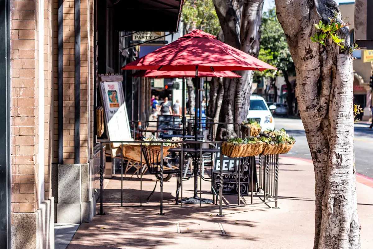 Tree-lined sidewalk and shopfronts in downtown San Luis Obispo
